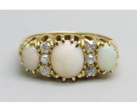 An 18ct gold three stone opal and diamond ring, 3.2g, M 