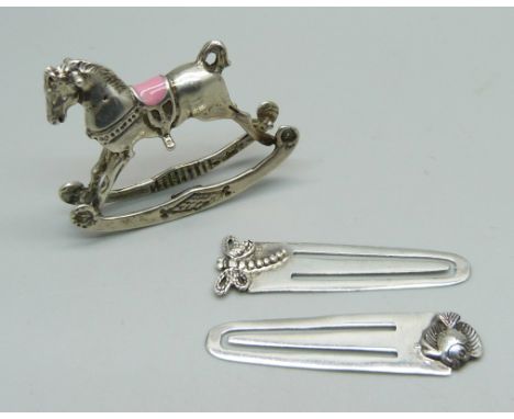 An .800 silver rocking horse and two silver book markers 