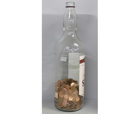 A 4.5 litre Bell's Finest Old Scotch Whisky bottle, approximately 30% full with copper 1p and 2p coinage **PLEASE NOTE THIS L