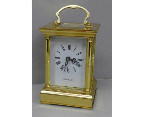 A 20th Century solid brass four glass sided carriage clock, white enamel dial with Roman numerals, key wind (key included), t