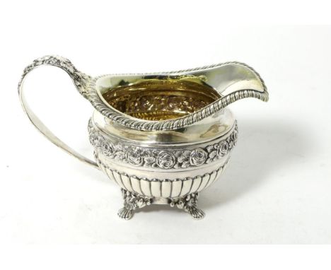 A George IV Silver Cream Jug, mark either that of William Eaton or William Elliott, London 1820, with gadroon border on four 