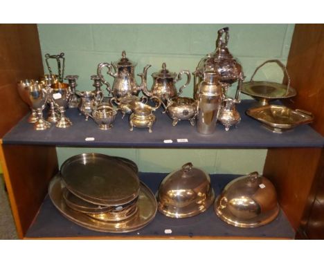A group of assorted silver plated items to include tea services; goblets; twin handled trays; meat covers etc (two shelves) 
