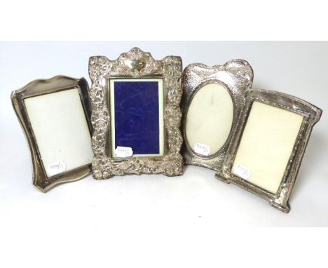 An Edwardian Art Nouveau silver photograph frame, AE Bromet, Birmingham 1902; together with three further examples, the first
