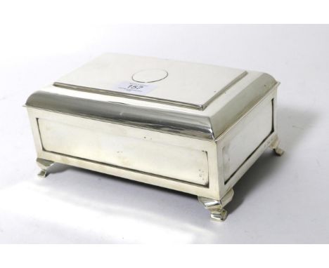 A George V Silver Table Cigarette Box, A & J Zimmerman, Birmingham 1911, with hinged cover, wood lined interior and on bracke