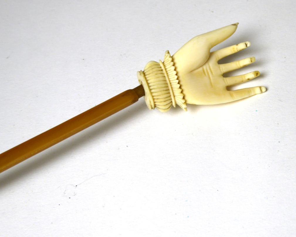 A late Victorian rhino horn and carved ivory back scratcher