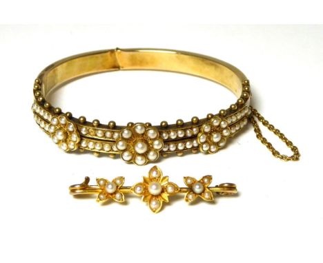A seed pearl bangle, two rows of seed pearls with three applied floral clusters, measures 5.3cm by 5cm inner diameter; and a 