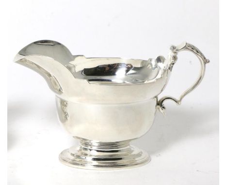 A Silver Helmet Shaped Sauce Boat, Garrard & Co, London 1973, of heavy gauge, with shaped rim, foliate capped scroll handle a