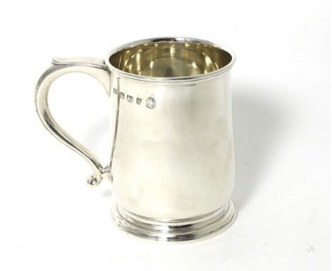 A Silver Mug, Mappin & Webb, Sheffield 1952, plain on circular foot, with scroll handle, 11.5cm high, 9.6ozt 