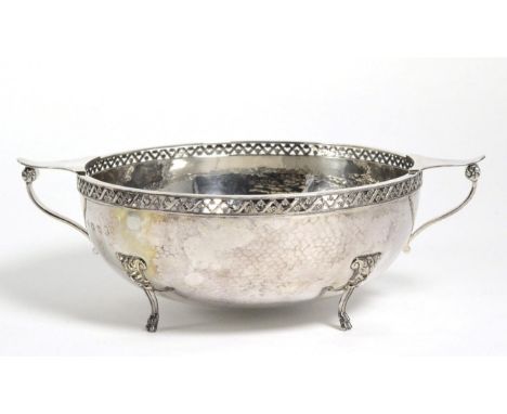 A George V Silver Twin Handled Bowl, A E Jones, Birmingham 1934, in the Arts and Crafts manner, with pierced rim, planished b