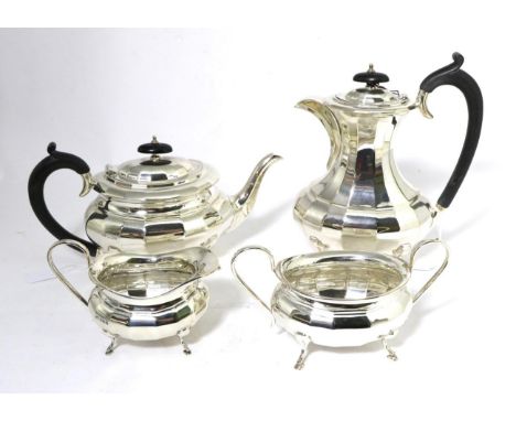 A George V Silver Four Piece Tea Service, Viners Ltd, Sheffield 1931, of faceted oval form, the hot water jug 23cm high, 57.5