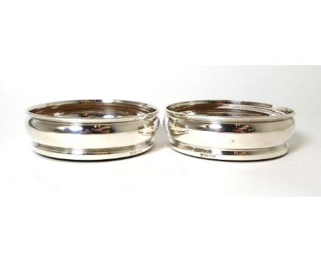 A pair of modern silver wine coasters, London 1976, 13.5cm diameter  