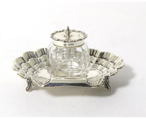 An Edwardian Silver Inkstand, Horace Woodward & Co Ltd, London 1903, of shell form on foliate bracket feet with a single deta