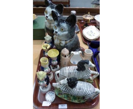 A pair of Staffordshire zebras, on green and brown mottled bases, 22cm; a pair of large Staffordshire seated cats, with glass