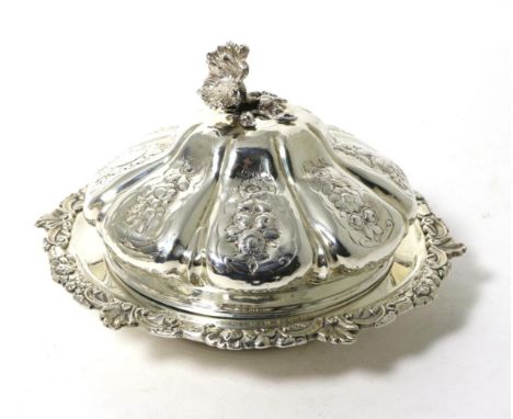 A William IV Silver Muffin Dish and Cover, maker's mark IW, London 1830, the lobed cover decorated with floral panels and wit
