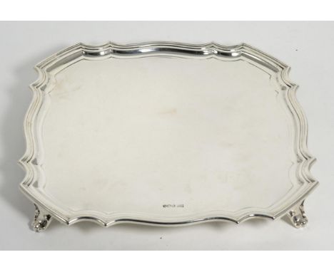 A Shaped Square Silver Salver, Walker & Hall, Sheffield 1927, standing on four bracket feet, 31cm wide, 30.8ozt Clear marks, 