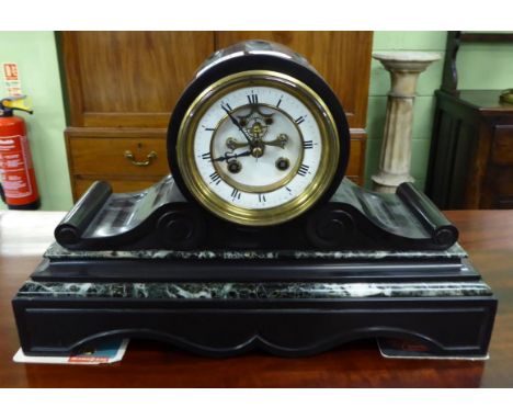 A black slate and marble striking mantel clock