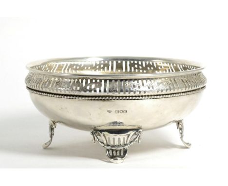 An Edwardian Silver Bowl, Goldsmiths & Silversmiths, London 1909, with a pierced and engraved rim and on four pierced swag br