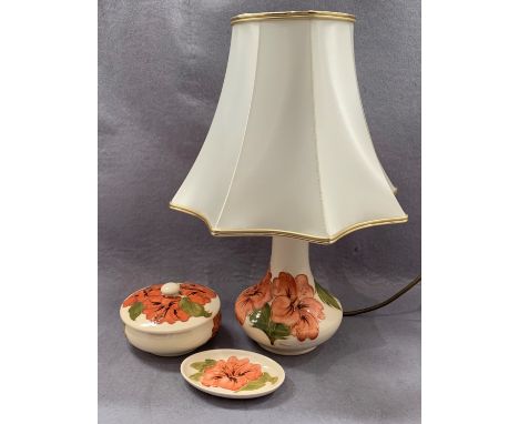 A Moorcroft table lamp in cream glaze floral pattern 23cm high complete with shade, a matching bowl with cover 12cm diameter 