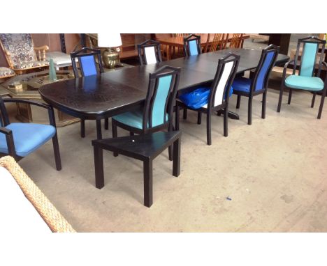 A large black ash effect extending dining table (four leaves) approx 3.5m long x 1m wide with 8 matching dining chairs (two c