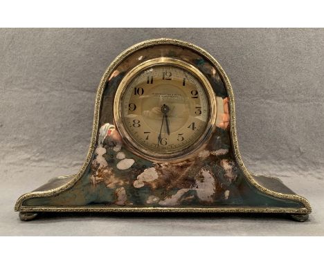 An Edwardian mantel clock, the swept, arched, plated case with French brass cylinder movement, bun feet, 29cm wide