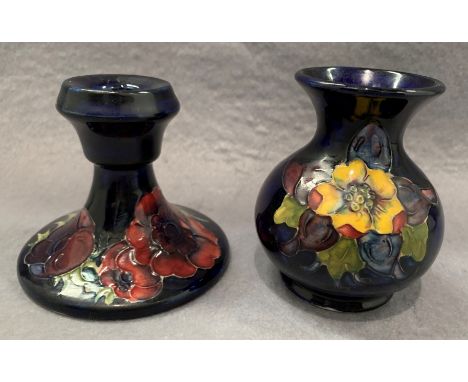 A Moorcroft candlestick in blue glaze floral pattern 10cm and a small Moorcroft vase in blue glaze floral pattern 10cm high (