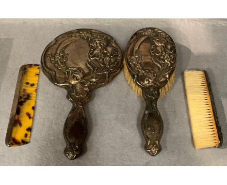 A silver art embossed hand mirror, hairbrush, together with a clothes brush and a comb (4) 