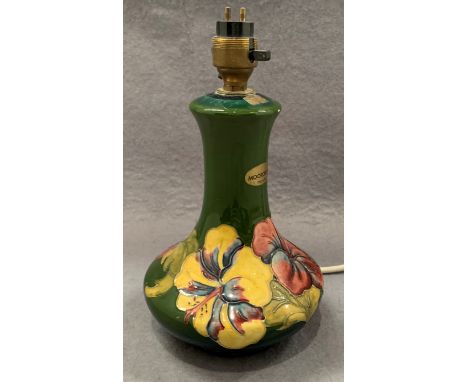A Moorcroft table lamp in green floral pattern glaze 24cm high (chip to base) - not tested - as seen 