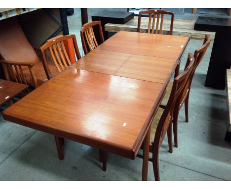 A Beithcraft Scotland teak extending dining table 183cm extended x 84cm together with four rail back dining chairs and  one c