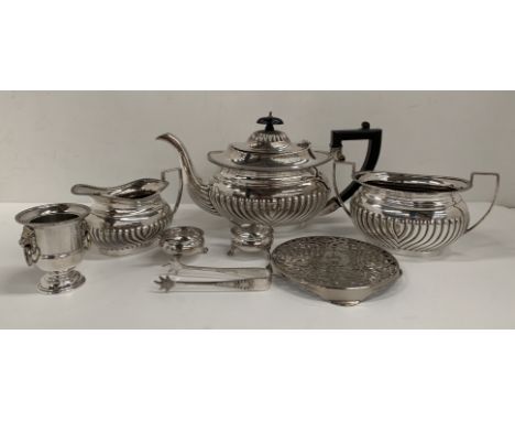 A plated three piece tea service, a plated stand, two plated salts and spoons, a Viners small plated urn and plated sugar ton