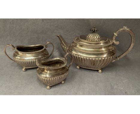 A three piece batchelor's tea service of semi-fluted, rounded rectangular form, ball feet, Sheffield 1900 (approximate gross 