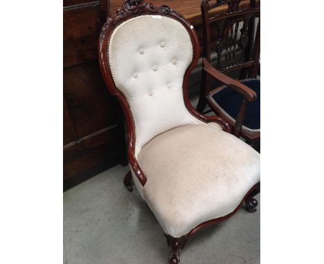 A mahogany framed nursing chair with mushroom button back upholstery 