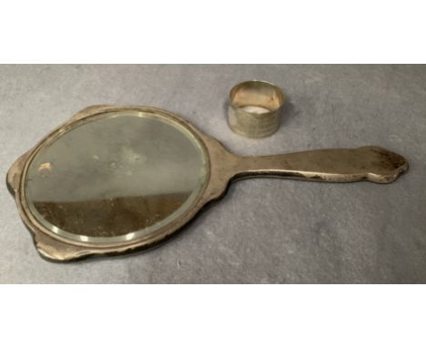 A silver mounted hand mirror, decorated with engine engraving, Birmingham 1919, together with an engine engraved circular nap