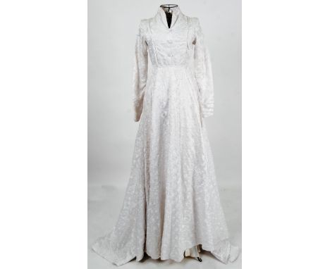 WEDDING DRESS: A vintage 1970's original ivory silk wedding dress . Silk covered buttons to neck with silk embroidered floral