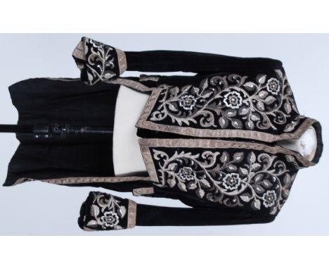 TAIL COAT: An ambassadors tail coat , black velvet with nehru style collar . Hand stitched floral applied silver thread embro