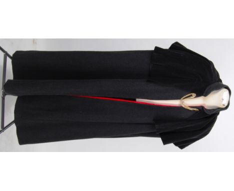 CAPE: A gentlemans long black woolen cape with short black velvet top cape . Fully lined in red satin with a golden coloured 