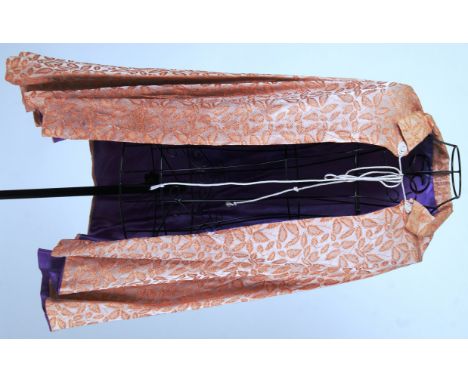 CAPE: A vintage original leaf motif cape. Peach coloured satin cloth with purple satin lining.


NOTE: From a large private c