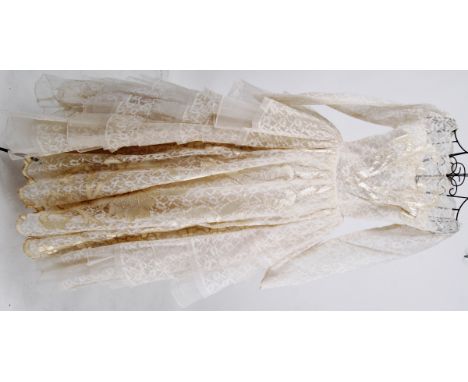 WEDDING DRESS: An original vintage 1960's wedding dress . Full length in lace with silk patterned panelling , the full bodied