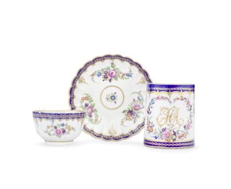 A Worcester mug and a teacup and saucer, circa 1775-80With deep blue and gilt chain borders, the small cylindrical mug initia