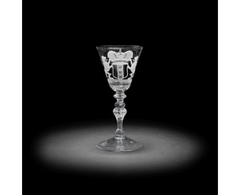 A Dutch engraved armorial light baluster wine glass, circa 1755The round funnel bowl decorated with the coat of arms of Amste