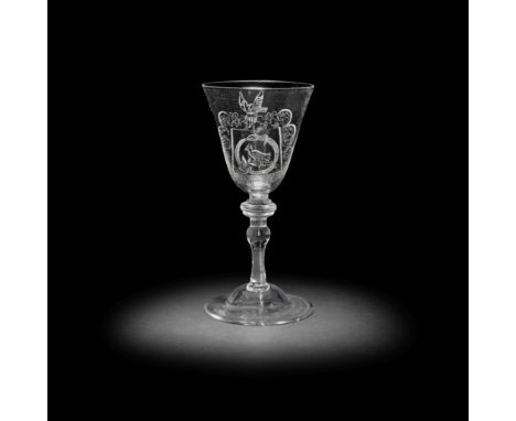 A Dutch engraved armorial light baluster goblet, circa 1750The engraving later, the generous round funnel bowl naively decora