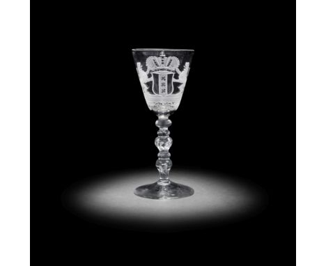 A Dutch engraved armorial light baluster wine glass, circa 1750The round funnel bowl decorated with the coat of arms of Amste