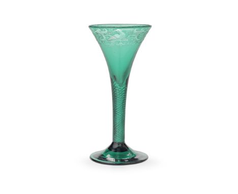 An exceptional emerald-green engraved airtwist wine glass, circa 1750The drawn trumpet bowl finely decorated with an elaborat