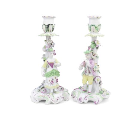 A pair of Derby 'Pale Family' candlestick figures, circa 1756-58Modelled as a farmer and his wife, each standing before a tru