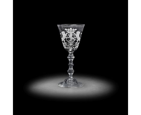 A Dutch engraved armorial light baluster goblet, circa 1750The generous round funnel bowl with the crowned arms of South Holl
