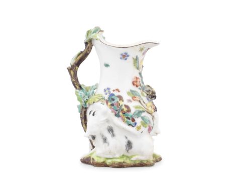 A Chelsea 'Goat and Bee' jug, circa 1745-47Of pear shape, supported by two goats recumbent nose to tail on grass, applied in 