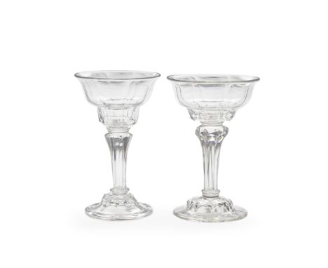 Two moulded-stem sweetmeat glasses, circa 1740-50The panel-moulded lipped double ogee bowls raised on eight-sided pedestal st