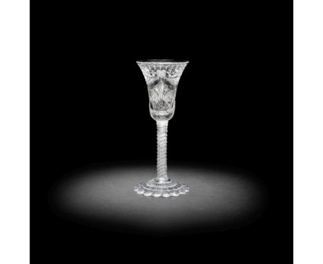 A rare and unusual cut and engraved opaque twist wine glass, circa 1765The bell bowl elaborately decorated with swags of frui