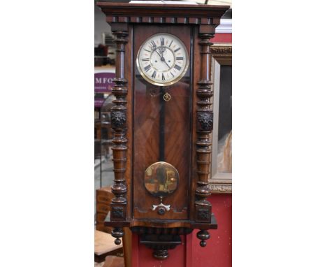 A 19th century walnut Vienna regulator wall clock, 18cm enamel dial, twin-winding holes, the case with stepped pediment, flan