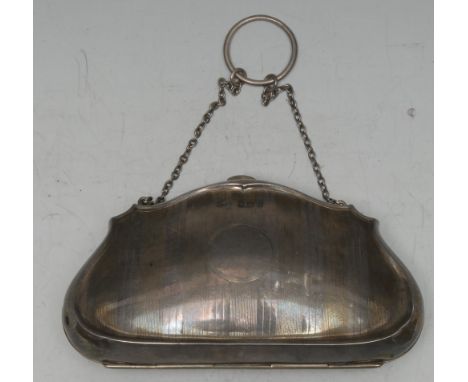 A George V silver bag shaped evening purse, engine turned and centred by a vacant circular cartouche, suspension chain, leath