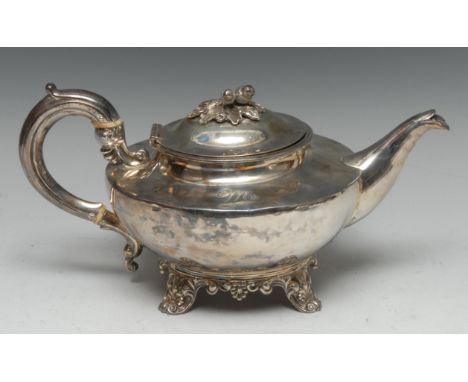 A William IV silver teapot, hinged domed cover with fruiting oak finial, scroll-capped handle, anthemion scroll feet, 29cm lo